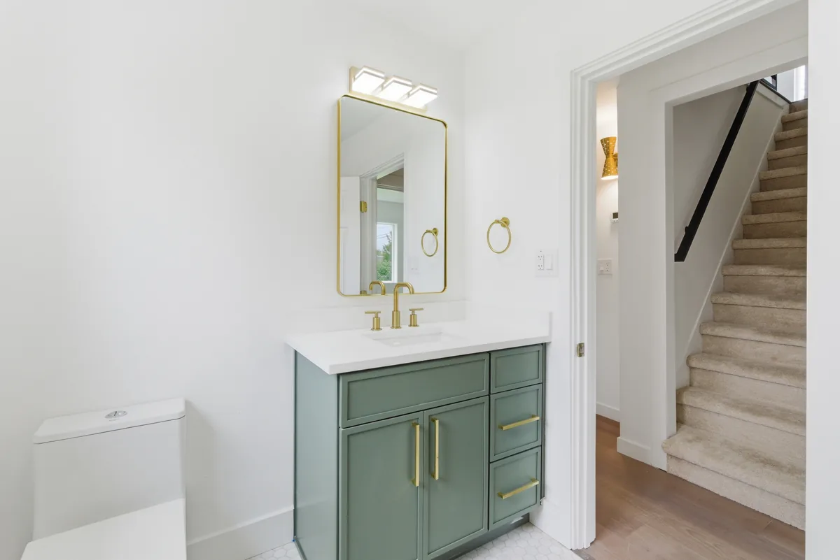 Bath floor and vanity. Floor tile set to the vanity and door casing with tight, even grout lines.